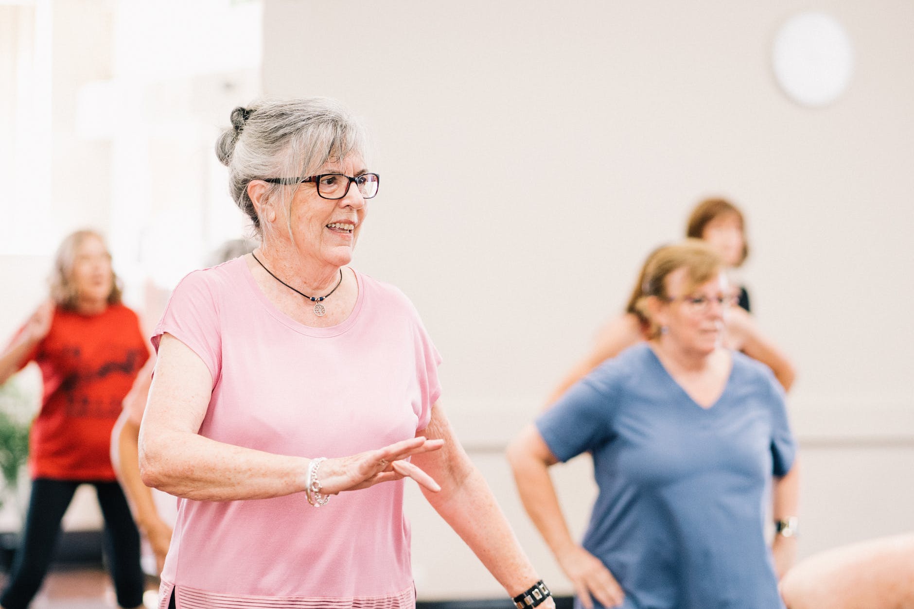 elderly woman in pink shirt dancing