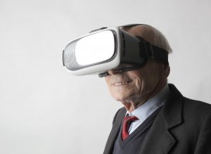 senior man using vr goggles in studio I Virtual Reality vs Augmented Reality I Sharanda Strong Henry I StrongLink Technology