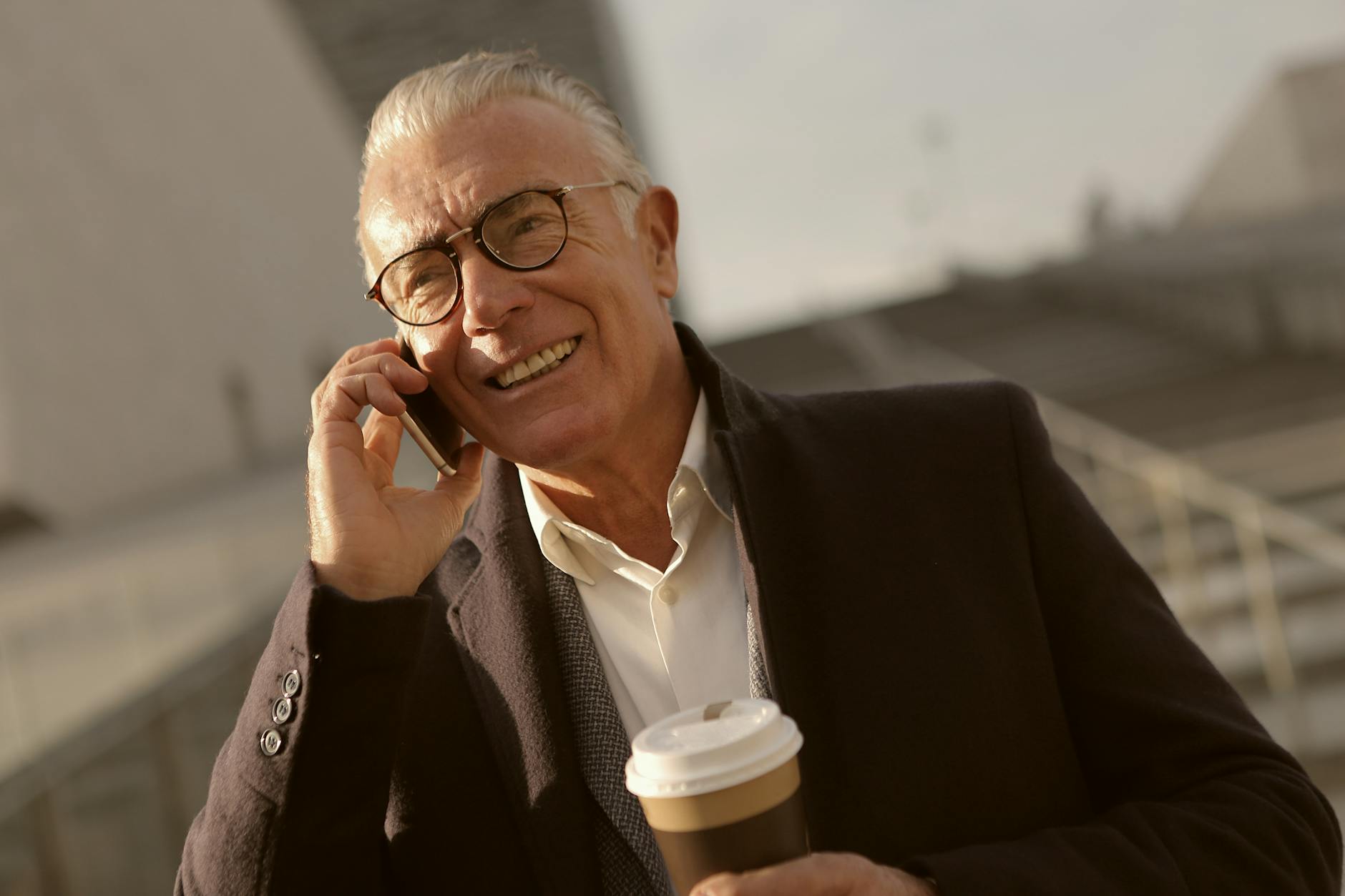 man in black suit jacket wearing eyeglasses