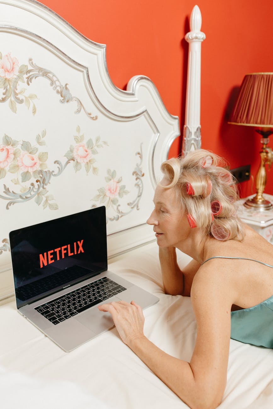 a woman watching on a laptop