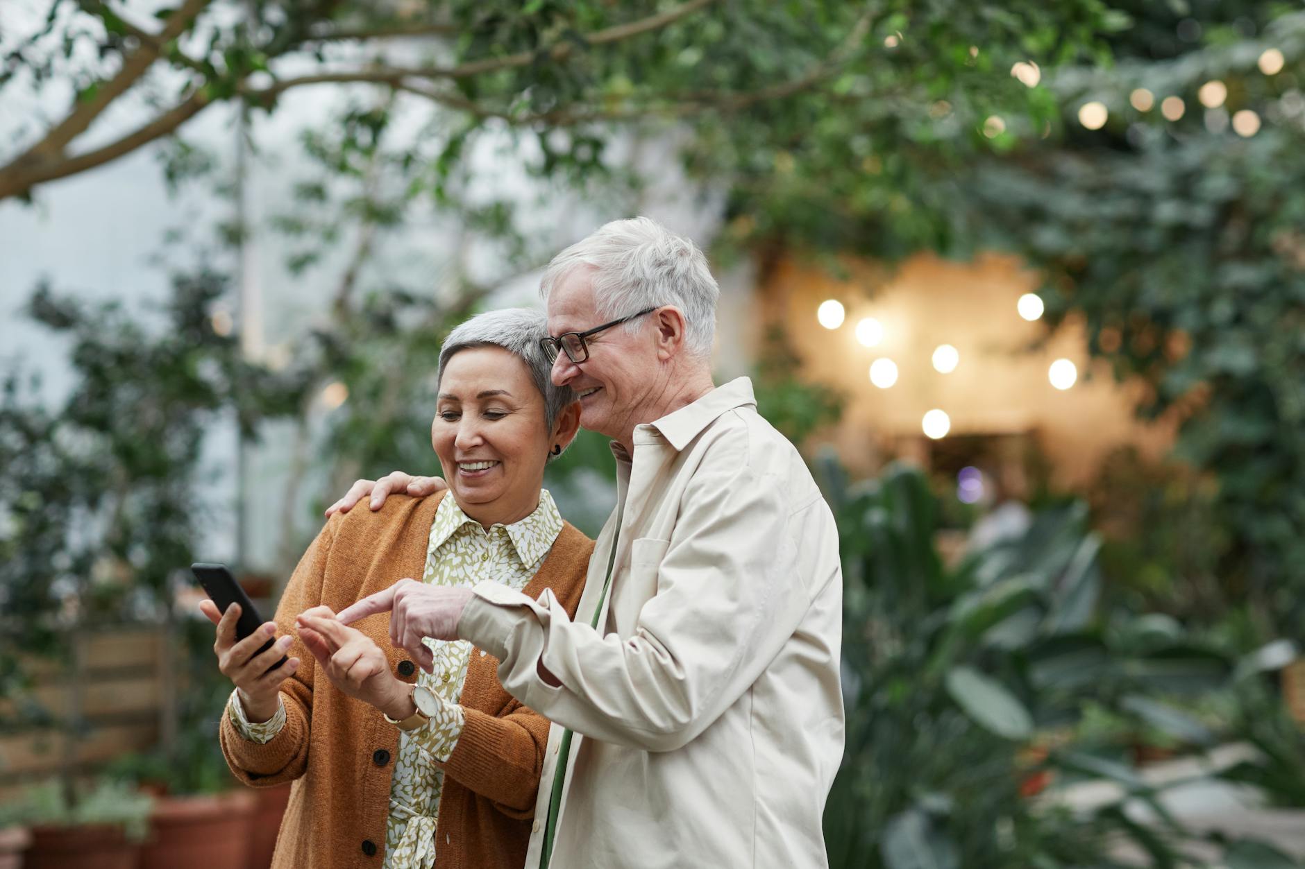 couple smiling while looking at a smartphone