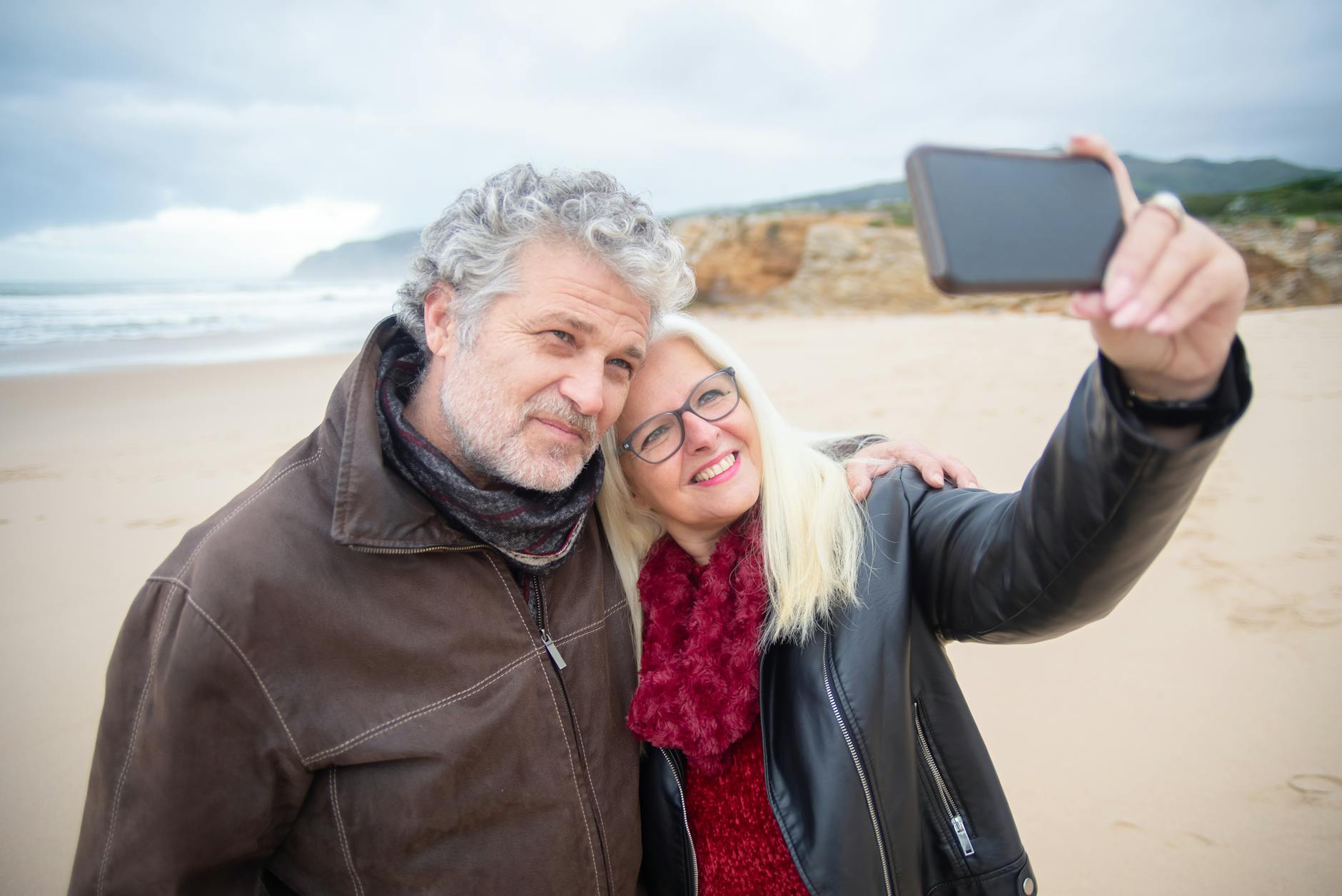 a couple taking a selfie in the beach