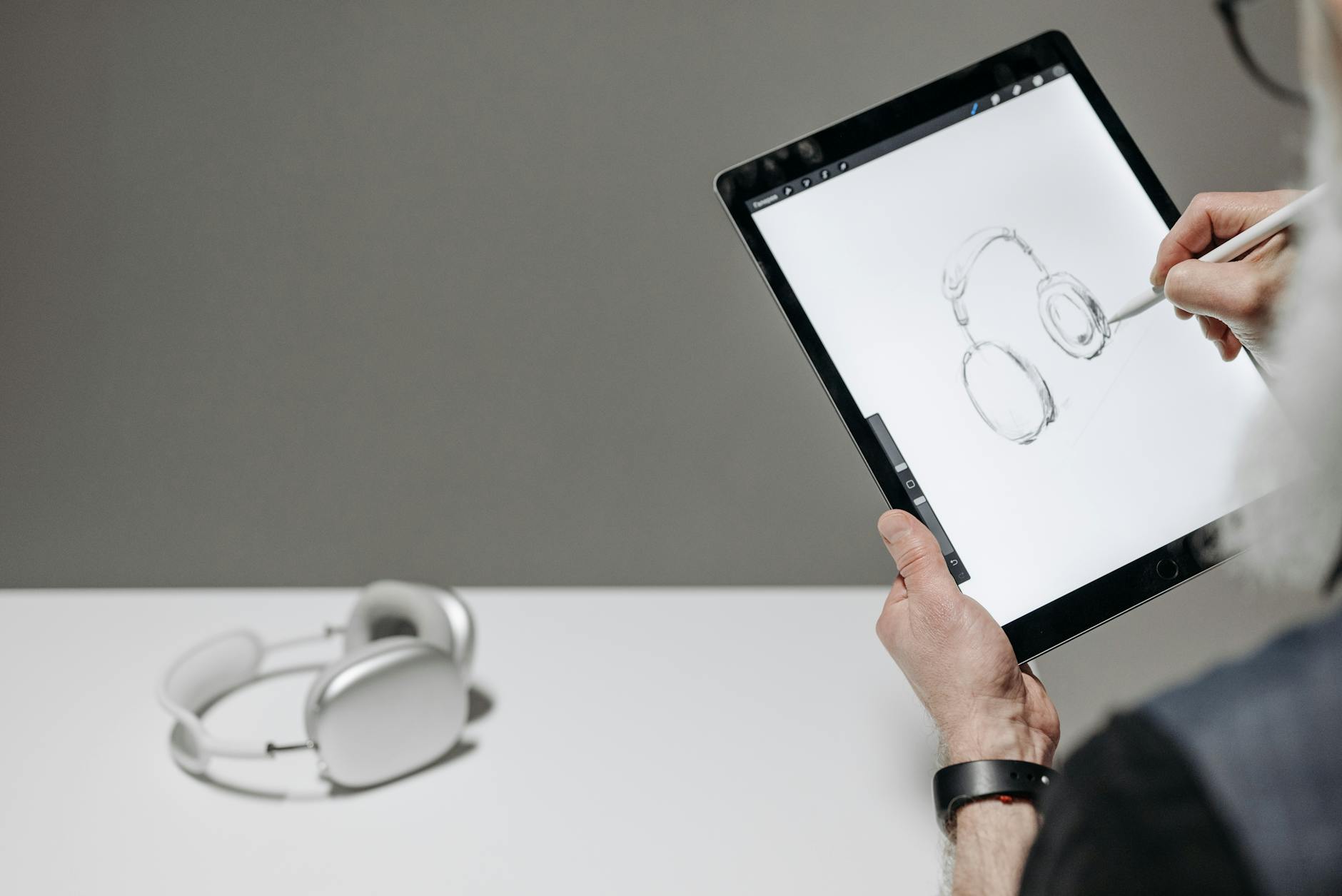 a person drawing on a tablet with a stylus