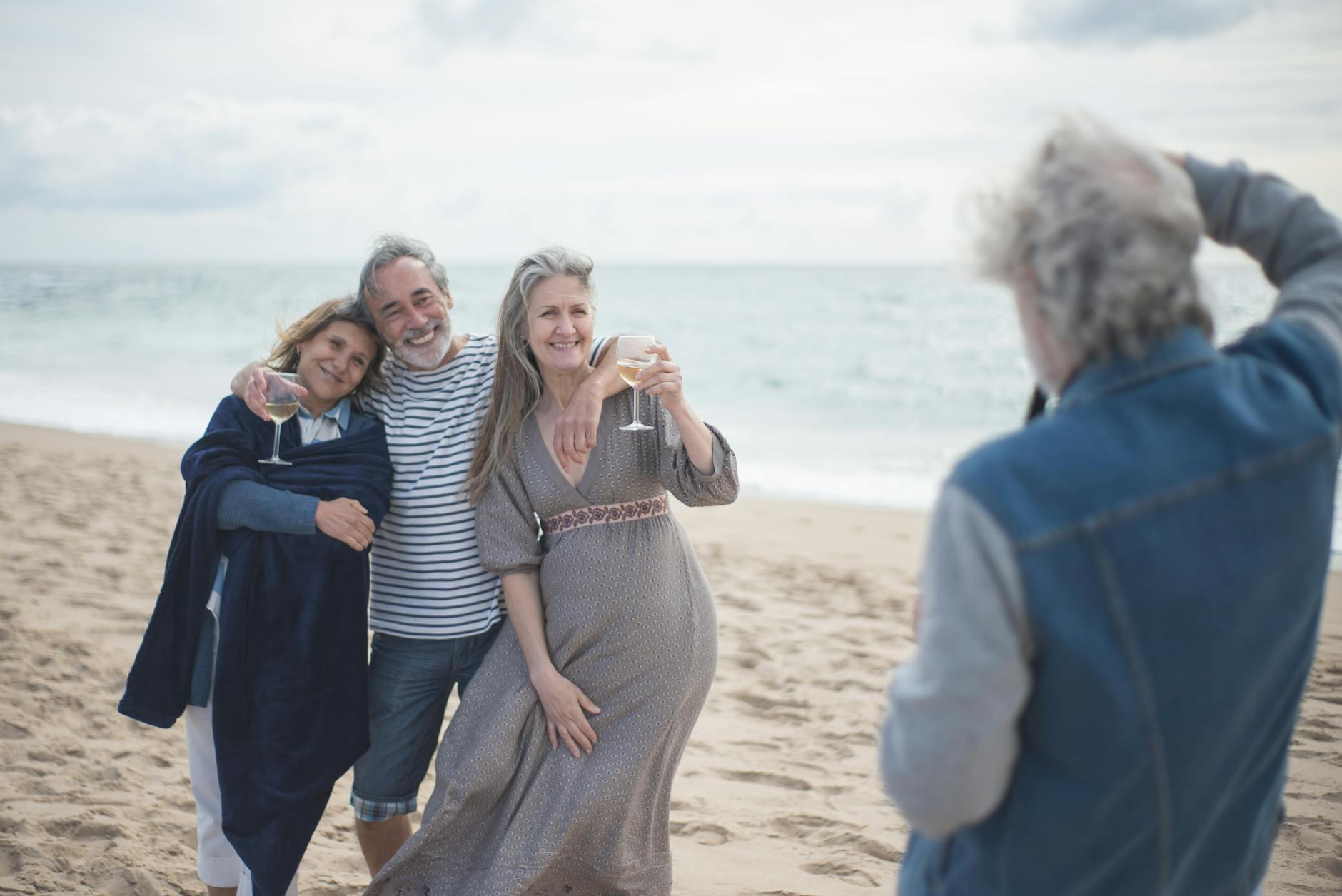 people near the seashore holding wine glasses