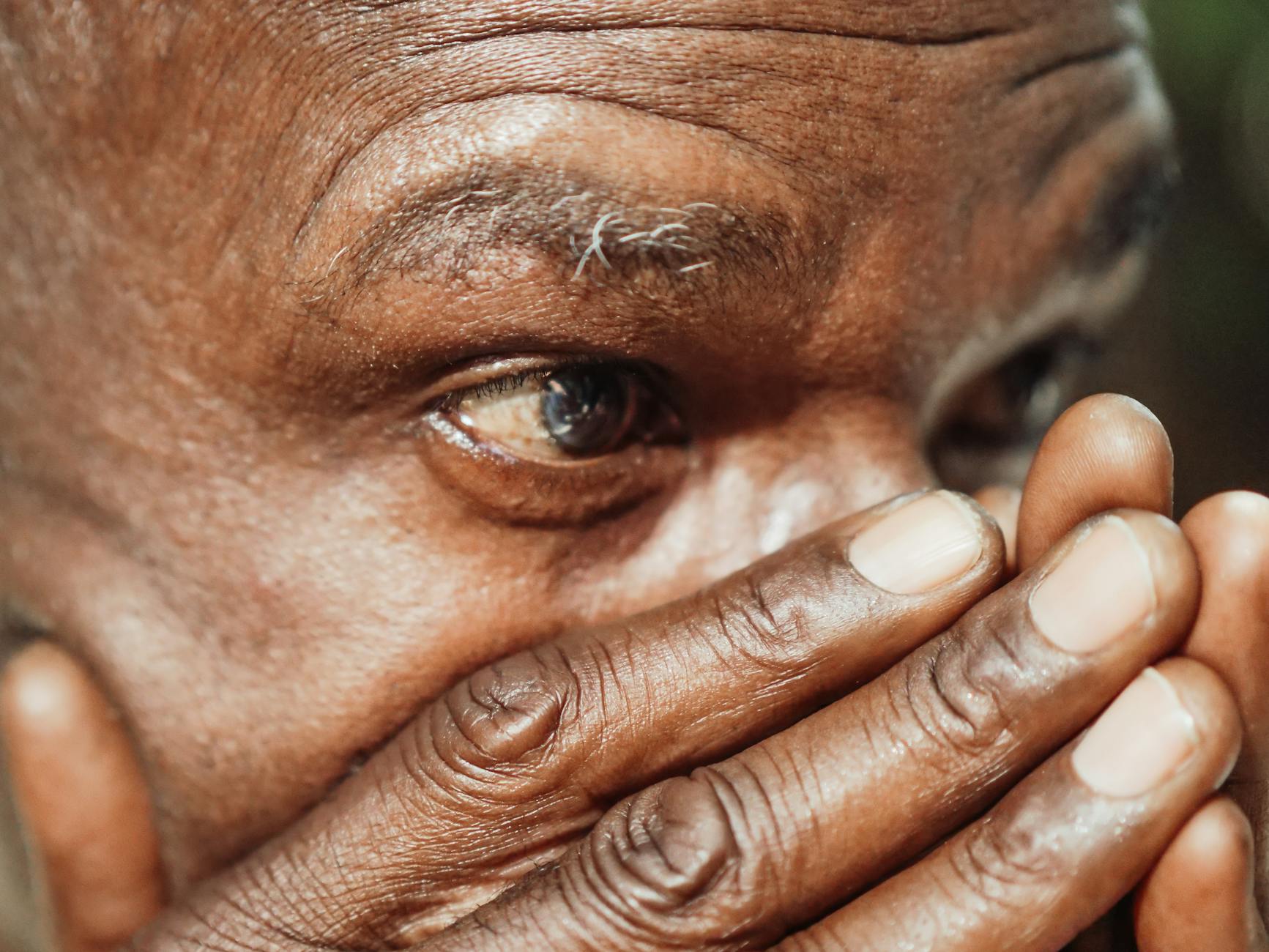 close up shot of a man covering his face